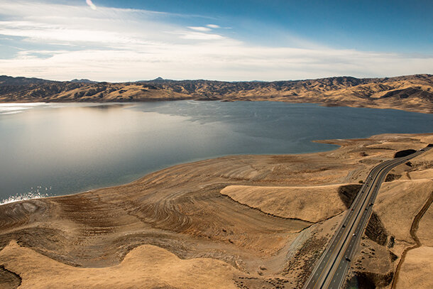 Aerial photo of San Luis Reservoir in CA, surrounded by dry, grassy areas