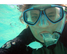 Caroline Rogers underwater in a scuba mask 