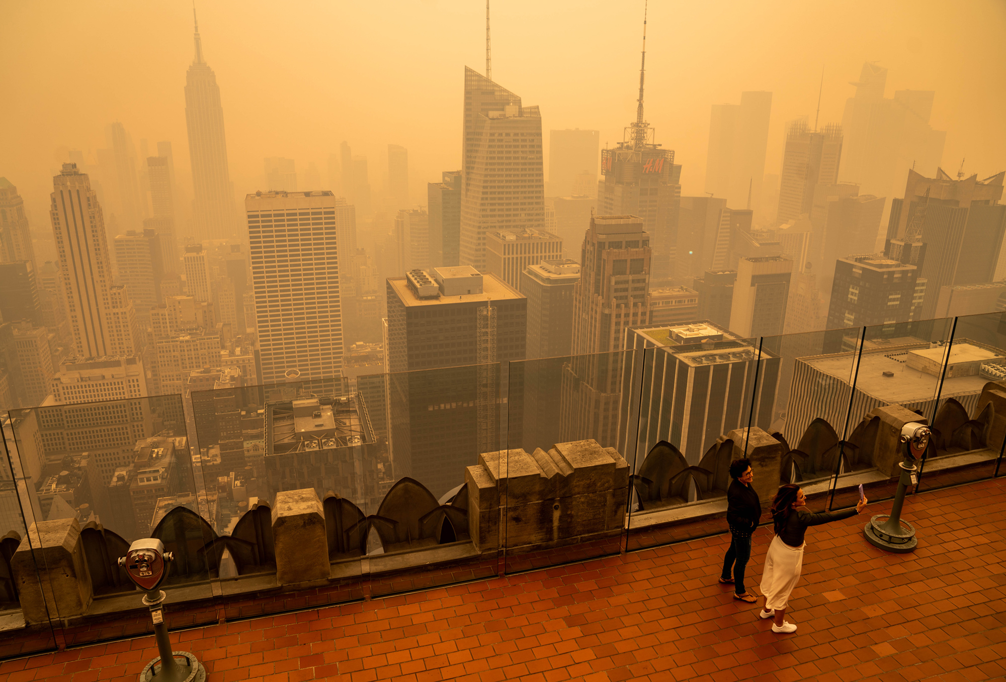 Yellow smog partially obscures buildings in a photo captured from a high-rise building