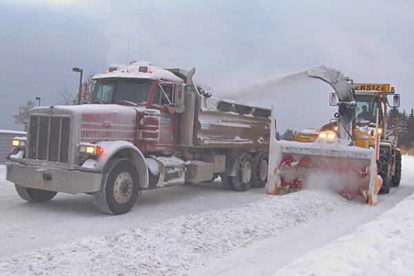 Photo of dump truck and snowplow preparing roads for winter conditions 