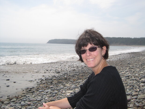 Ellen Mecray on a cobbled beach