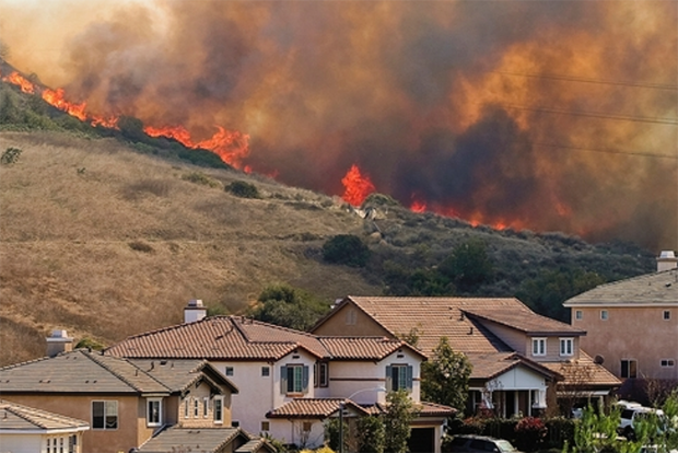 Fire burning near homes