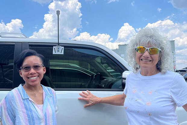 Two mappers standing next to vehicle