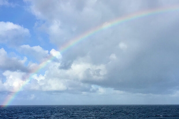 Photo of rainbow over ocean