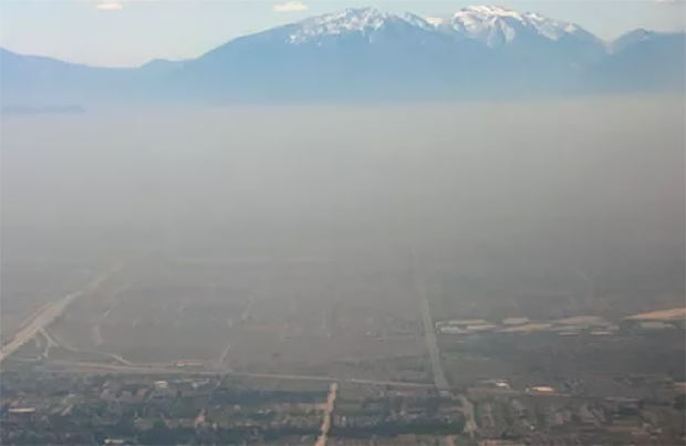 Aerial photo of smog in foreground, mountains in background