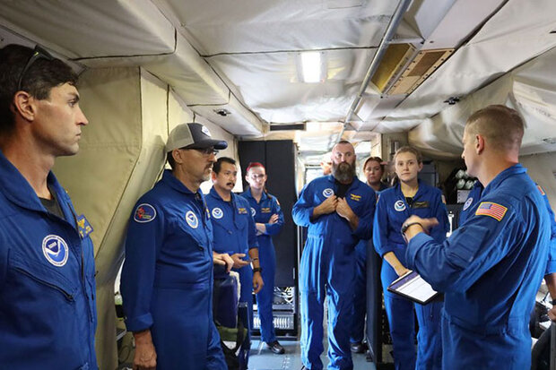 Photo of people talking inside research plane