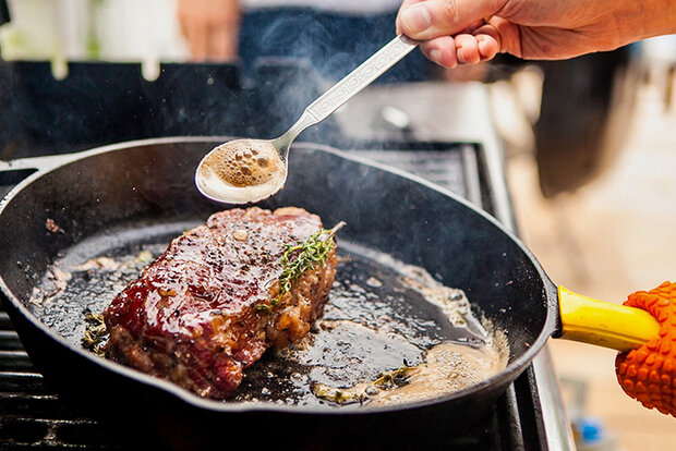 Meat cooking in frying pan
