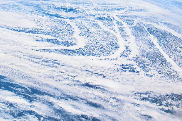 Contrails and clouds over ocean