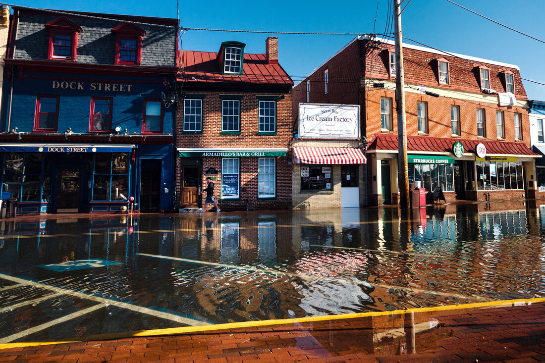 flooded parking places and street in front of shops on Dock Street in Annapolis, MD