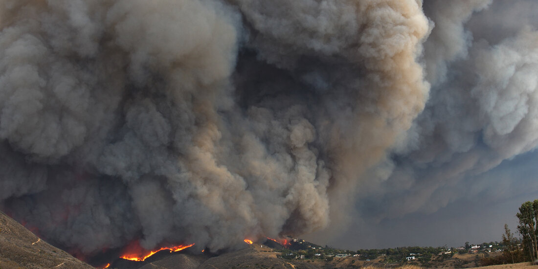 smoke billowing over hills