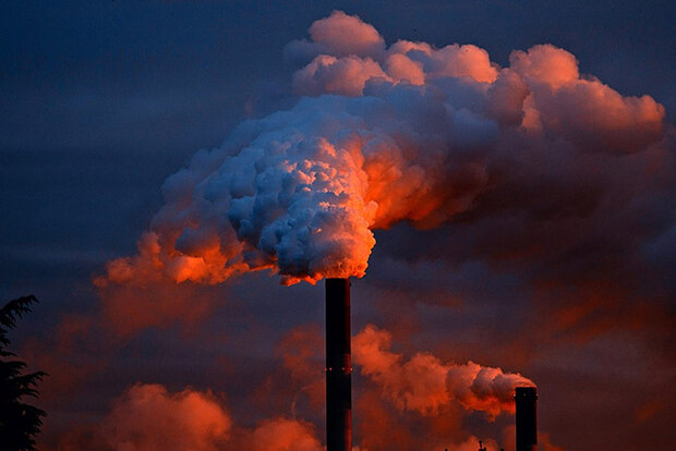 Smokestacks in low-angled sunlight