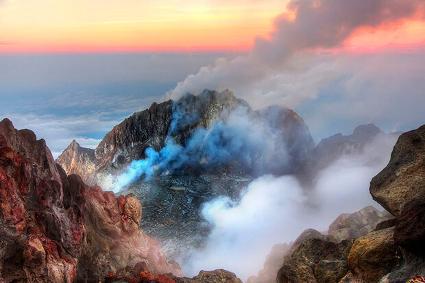 Photo of the summit caldera of Mt. Merapi billowing gas and steam