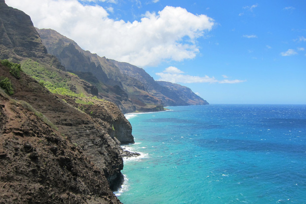 A steep volcanic cliff meeting the ocean on Hawaii